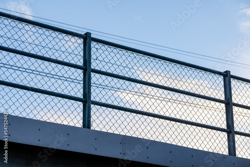 blue beautiful bright sky with a metal railing visible below it