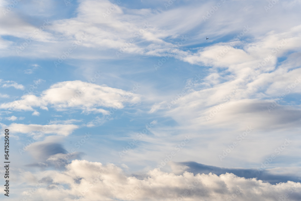 A beautiful blue autumn sky with white fluffy clouds makes for a fabulous overall view of the sky A beautiful blue autumn sky with white fluffy clouds makes for a fabulous overall view of the sky