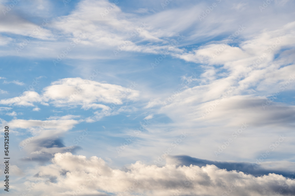 A beautiful blue autumn sky with white fluffy clouds makes for a fabulous overall view of the sky A beautiful blue autumn sky with white fluffy clouds makes for a fabulous overall view of the sky