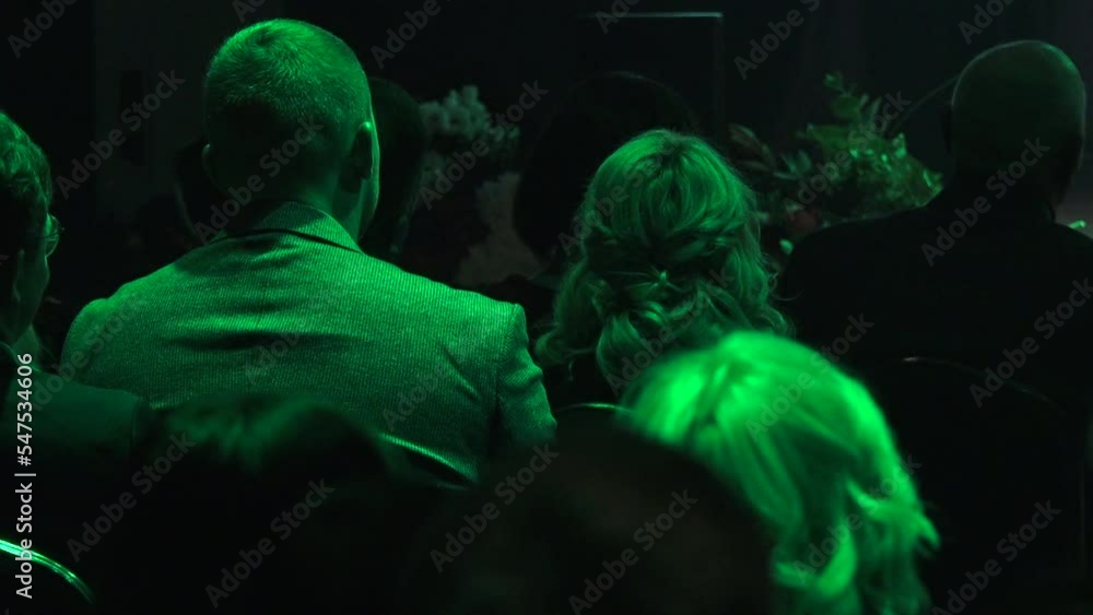 People sit with their backs in the concert hall. Human heads from behind. People sit with their backs in the concert hall. Human heads from behind.