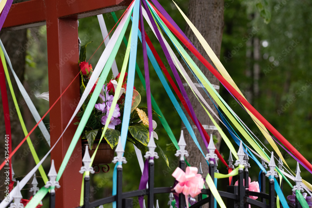 Shrine decorated with colorful stripes and ribbons. Meeting place for May services. Christian traditions in the countryside.