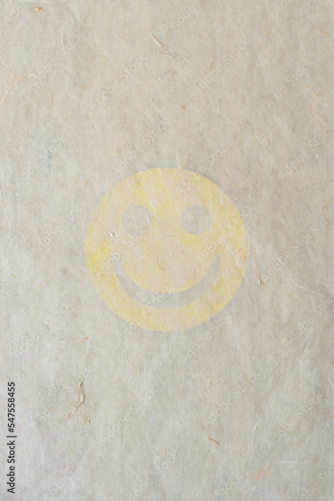 tissue paper with smiley cutout