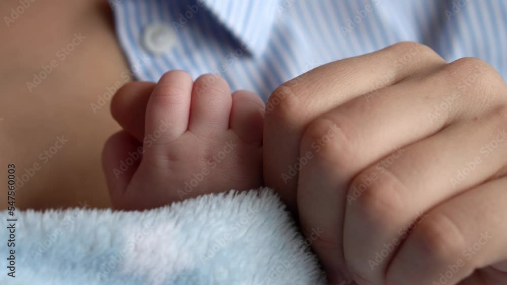 motherhood, childhood, family, care, health,medicine, dermatology, maternity concept. Mother mom holds kisses stroking little tiny hands fingers of infant newborn. close-up view of soft dry baby skin motherhood, childhood, family, care, health,medicine, dermatology, maternity concept. Mother mom holds kisses stroking little tiny hands fingers of infant newborn. close-up view of soft dry baby skin