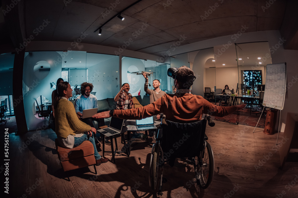 Business persons with a disability at work in modern open space coworking office on team meeting using virtual reality goggles. Business persons with a disability at work in modern open space coworking office on team meeting using virtual reality goggles.