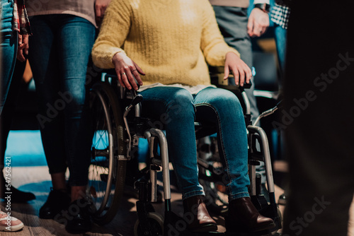 Close up photo of a woman with a disability sitting in a wheelchair in the office