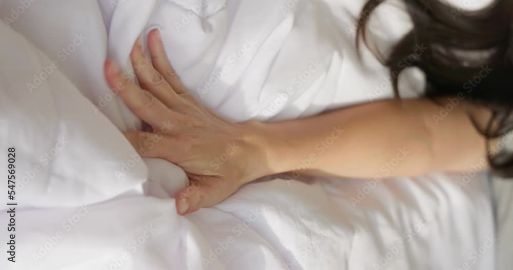 woman hand grasping sheets woman hand grasping sheets