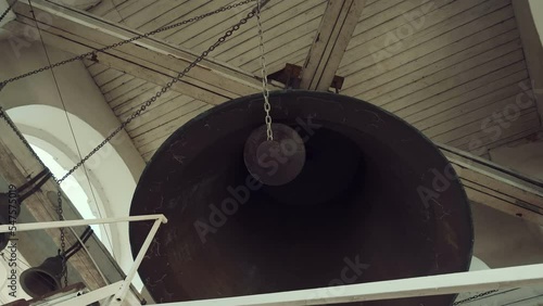 The main largest bell in the center and smaller at the edges on the bell tower of the Russian Orthodox Church, which is played by the bell ringer photo