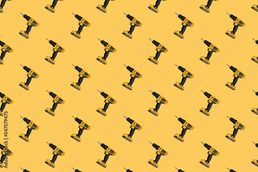 Seamless pattern. Cordless electric yellow screwdriver on a yellow background.