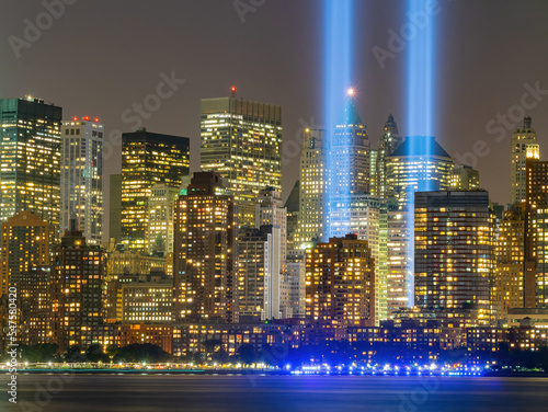 Night view of the 911 memorial light and the New York City skyline