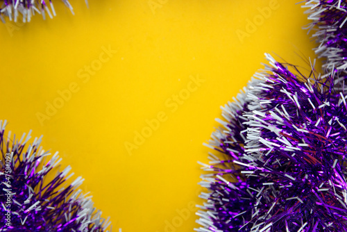  Christmas and new year party decorection. ribbons on yellow background and space for text. photo