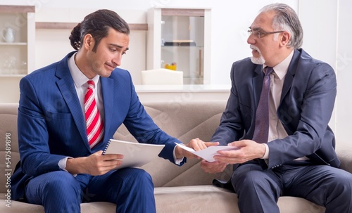 Two businessman discussing business in office