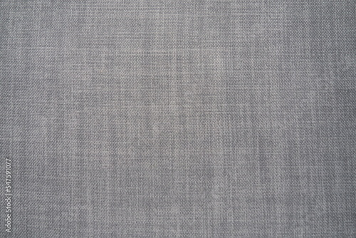 gray background fabric texture. A piece of woolen cloth is neatly laid out on the surface. Weave and textile texture. Dress fabric or for kitchen needs, tablecloth or curtains, close-up. Dash