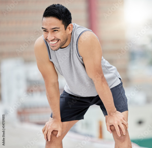 Fitness break, rest and happy man, city exercise and workout and motivation for fitness, body training and healthy lifestyle outdoors. Smile, tired and urban athlete breathing after sports challenge
