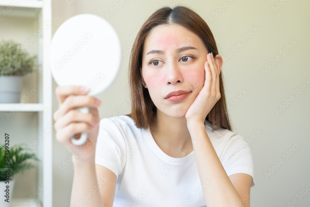 Dermatology, scratch asian young woman looking at mirror, expression worry and itch, itchy allergy or allergic sensitive reaction, red spot or rash on her face. Beauty care from skin problem treatment Dermatology, scratch asian young woman looking at mirror, expression worry and itch, itchy allergy or allergic sensitive reaction, red spot or rash on her face. Beauty care from skin problem treatment