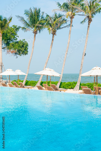 umbrella with bed pool around swimming pool with ocean sea background