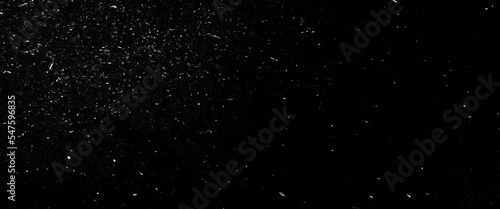 Abstract glitter background, snow imitation in silver, on black, white scratches isolated on a black background. template for design.