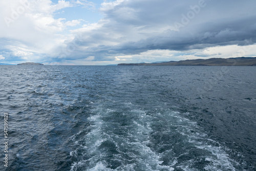 Clear fresh water of Lake Baikal on a summer day. Taken from a moving boat