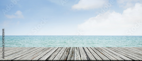 Table on Sea Background empty Wooden Desk Counter on Blue Ocean with Blue Sky on Sunny Day Light Mock Up Floor on Water Island at Coast Free Space for Tourism Vacation Travel Tropical Summer Holidays.