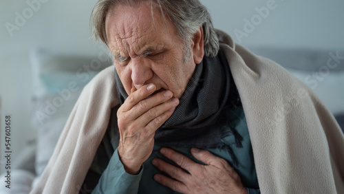 Portrait of coughing old man