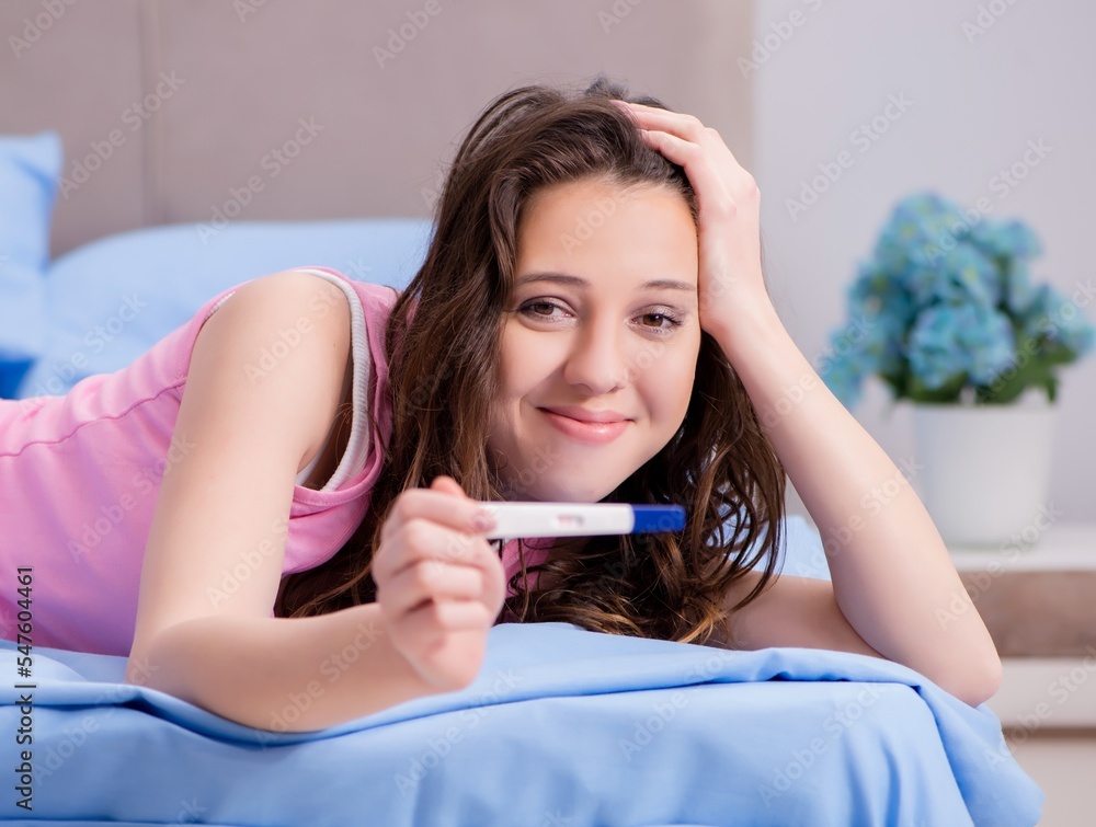 Woman discovering her positive pregnancy test Woman discovering her positive pregnancy test