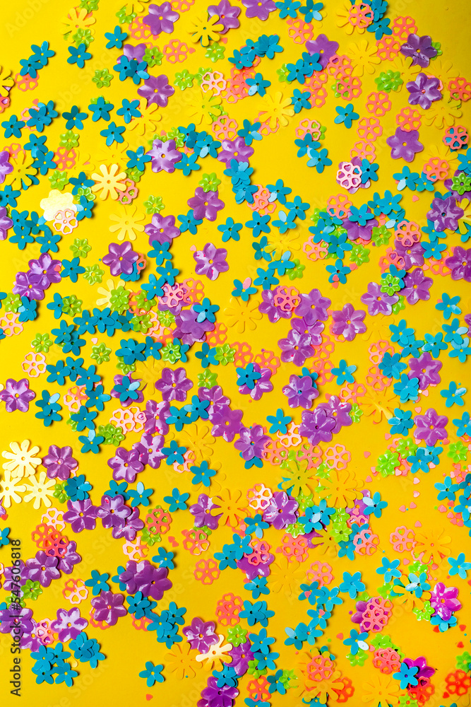 Abstract background of colored flowers on a yellow background