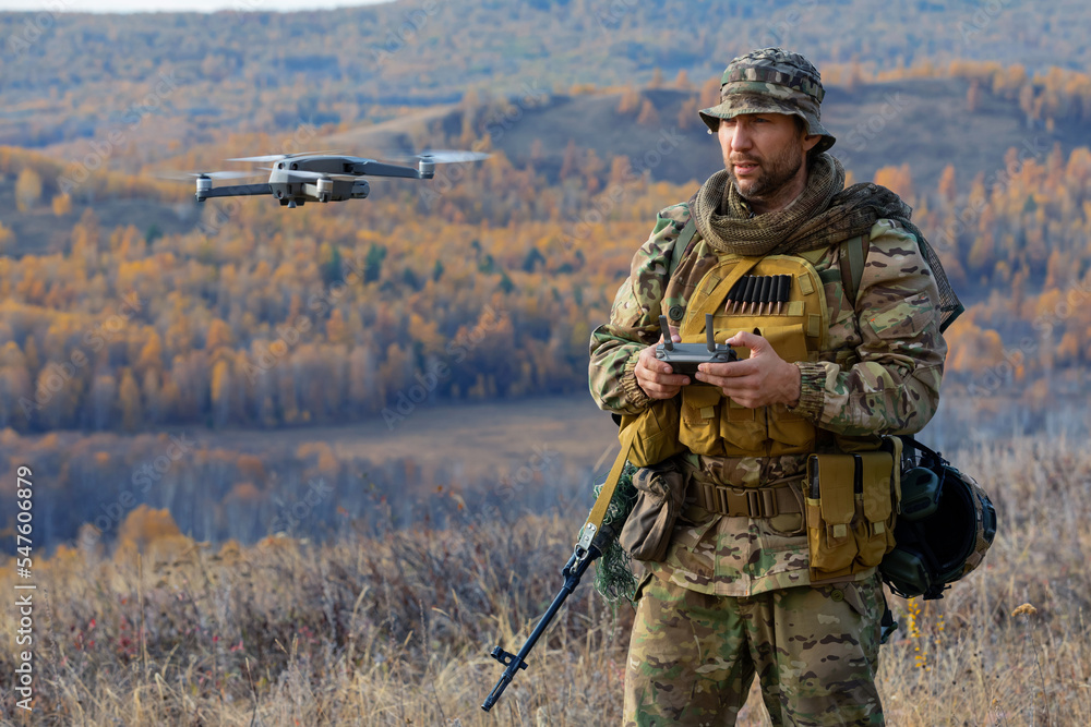 Fototapeta premium An artillery spotter or military observer launches a drone into the sky for reconnaissance in enemy territory.
