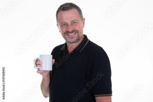 businessman handsome man wearing black shirt drinking mug tea coffee from cup on white background © OceanProd