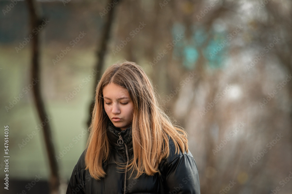 Portrait of a young beautiful woman in a dark autumn jacket. Portrait of a young beautiful woman in a dark autumn jacket.
