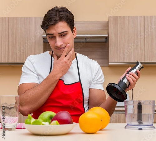 Handsome man working at the kitchen photo