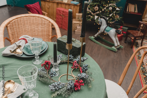 New Year's table setting Christmas in the style of the new year's fifties rustic antique style. decorated apartment without food with plates, candles and Christmas trees