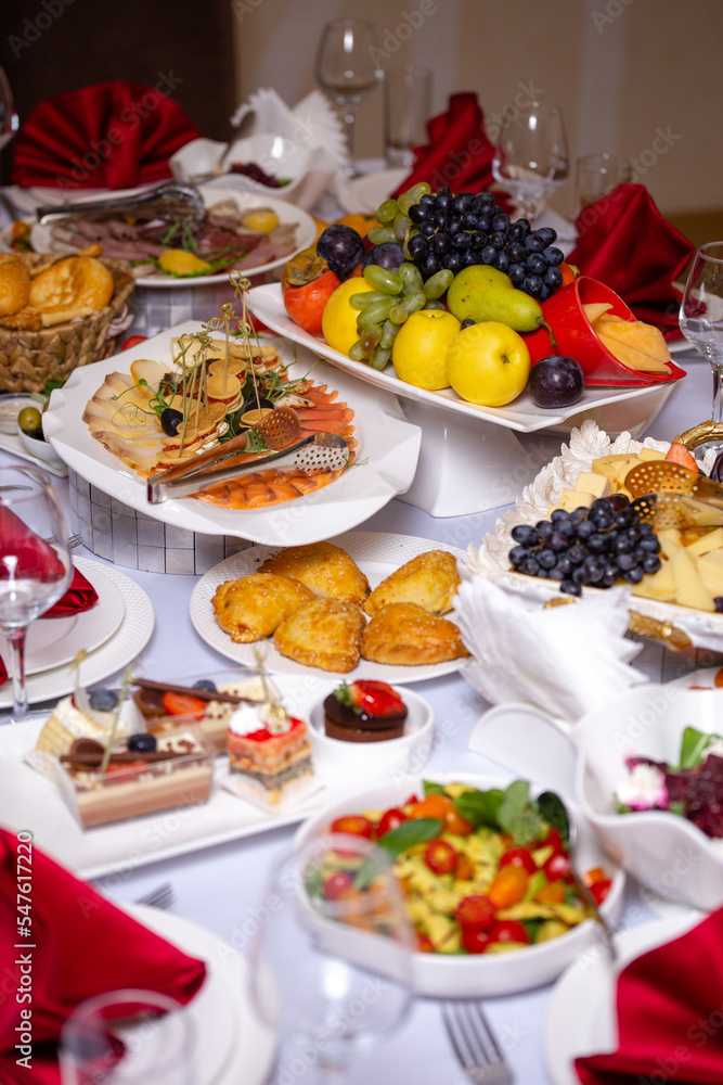 the table in the room is set in red tones with food for the holiday the table in the room is set in red tones with food for the holiday
