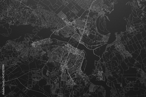Street map of Dnipro (Ukraine) on black paper with light coming from top photo