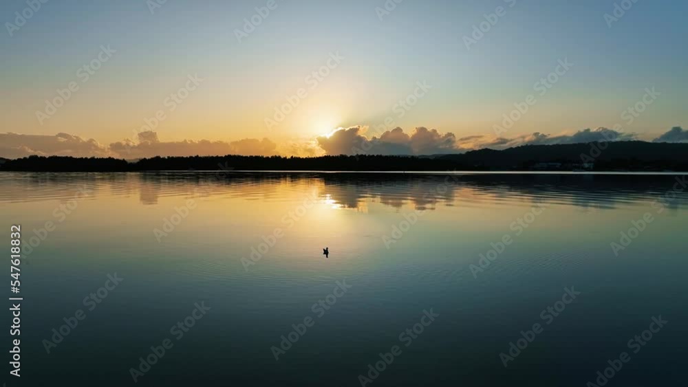 Aerial sunrise waterscape at the waterfront with clear skies and a bird in Woy Woy on the Central Coast, NSW, Australia. Aerial sunrise waterscape at the waterfront with clear skies and a bird in Woy Woy on the Central Coast, NSW, Australia.