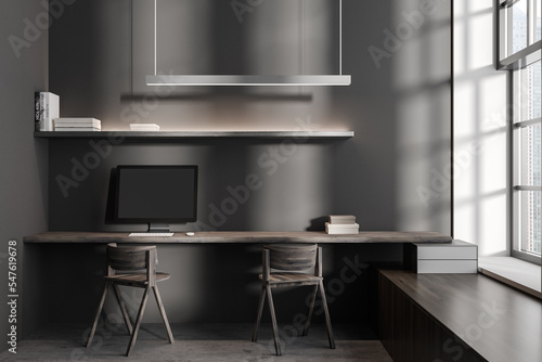 Grey business interior with workplace and pc computer, panoramic window