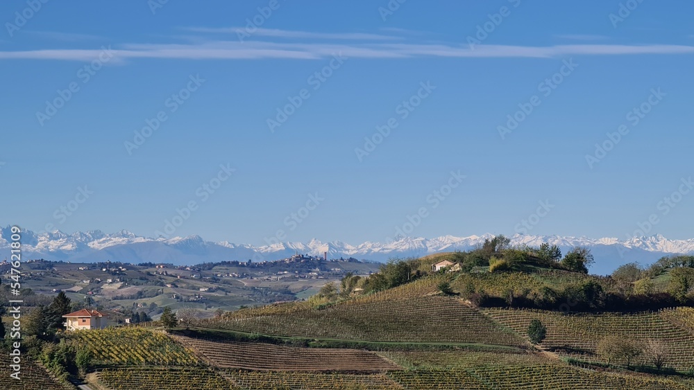 Alba, Italy-November 5, 2022: Beautiful hills and vineyards during fall season surrounding Alba village. Beautiful natural landscape from the small villages near Cuneo. 
