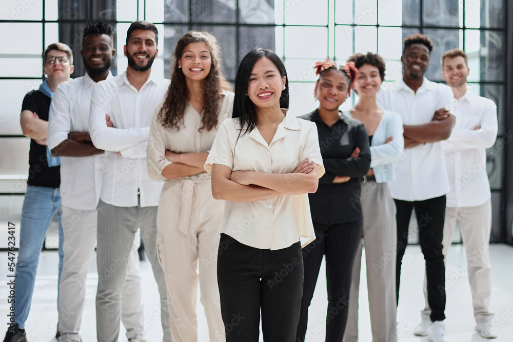 happy team of diverse corporate employees in the office lobby. happy team of diverse corporate employees in the office lobby.