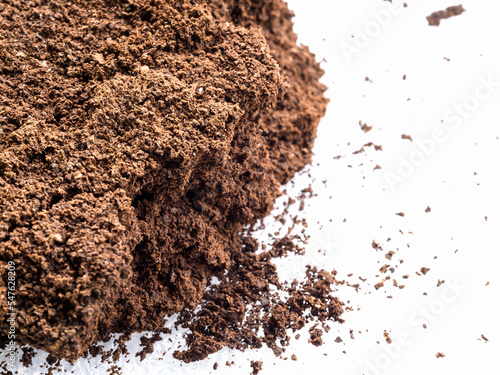 Ground coffee powder isolated on white background..Used coffee grounds after espresso machine and coffee beans on white  background.Caffeine addiction concept.