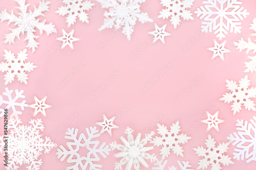 Festive Christmas magical ornate snowflake background on pastel pink. Fantasy design for winter, Xmas, New Year holiday season.