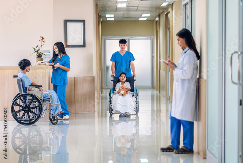 Group of professional medical doctor team work with stethoscope in uniform working discussing and talk with sick patient walking in hospital.health medical care concept