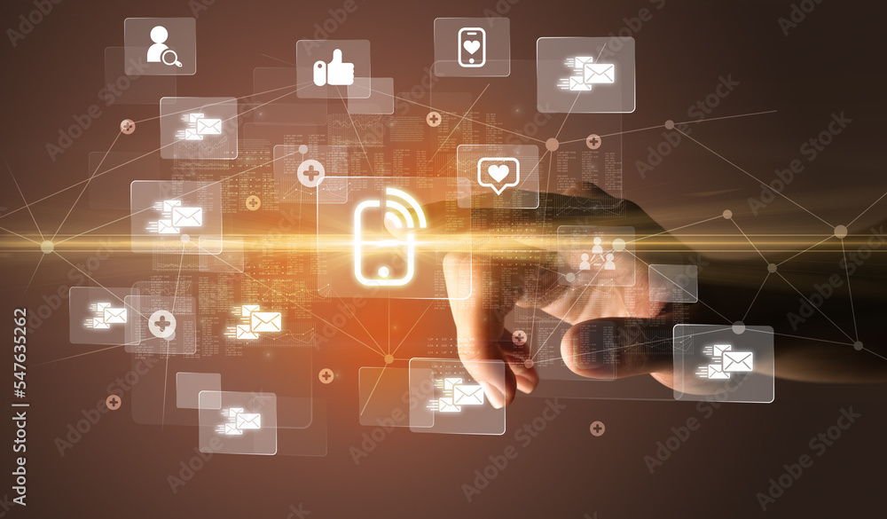 Hand pressing social media multimedia application screen with media icons on futuristic concept Hand pressing social media multimedia application screen with media icons on futuristic concept