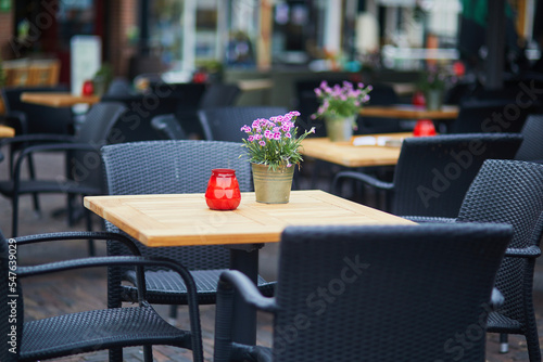 Photography Wooden table decorated with flower pot, candles and lantern in outdoor cafe in A
