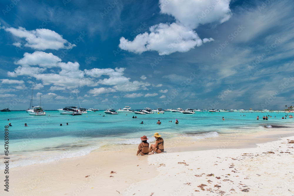ISLA MUJERES ISLAND, MEXICO APR 2022 2 sexy girls ladies are sitting