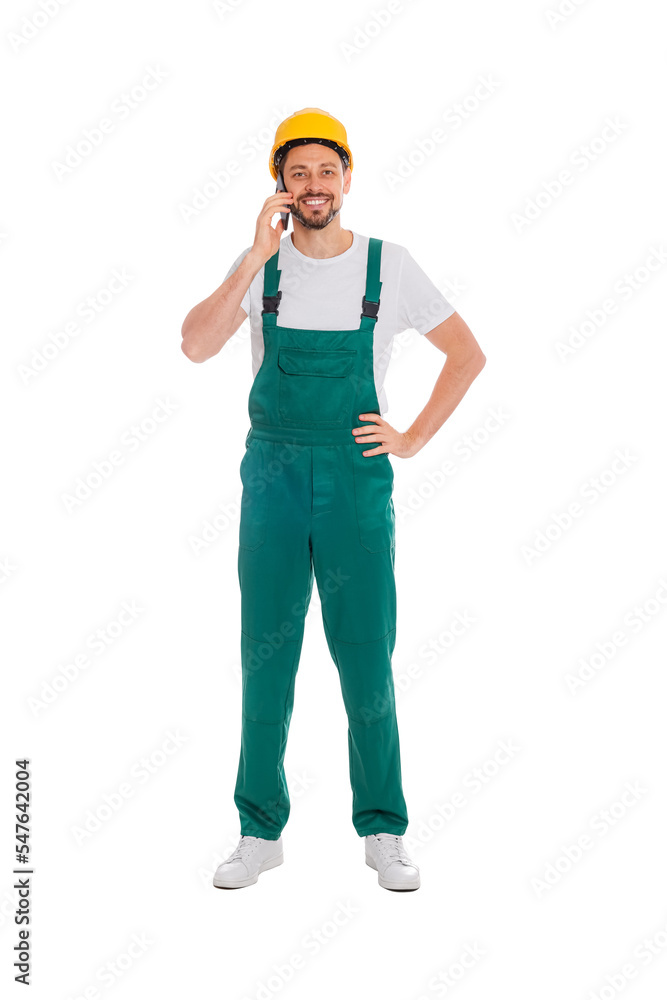 Professional repairman in uniform talking on phone against white background Professional repairman in uniform talking on phone against white background