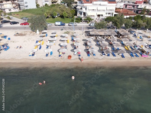 Fototapeta Naklejka Na Ścianę i Meble -  Aerial drone view plataria greece, beach crowded with tourists in vacation on summer in famous greek caribbean plataria town epirus thesprotia
