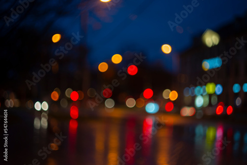 Photography Blurred view of city street with lights at winter rainy night