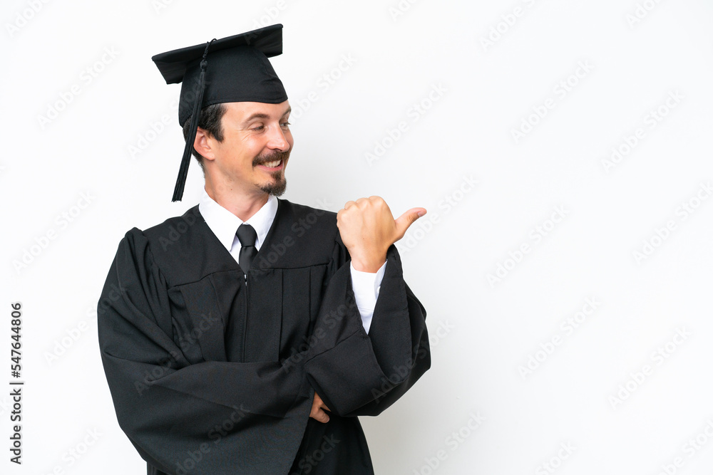 Young university graduate man isolated on white background pointing to the side to present a product Young university graduate man isolated on white background pointing to the side to present a product