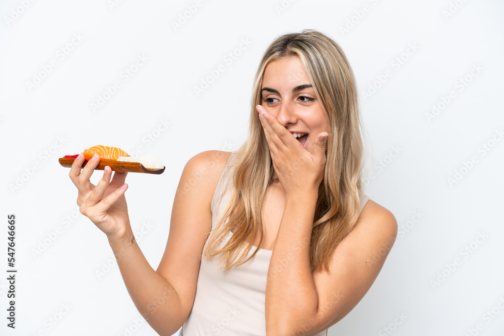 Young caucasian woman holding sashimi isolated on white background with surprise and shocked facial expression Young caucasian woman holding sashimi isolated on white background with surprise and shocked facial expression