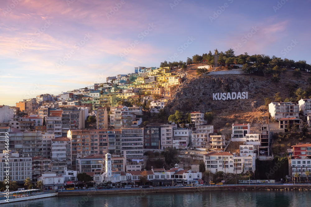 Homes and Buildings in a Touristic Town by the Aegean Sea. Kusadasi, Turkey. Colorful Sunrise Art Render. Aerial View from Cruise Ship