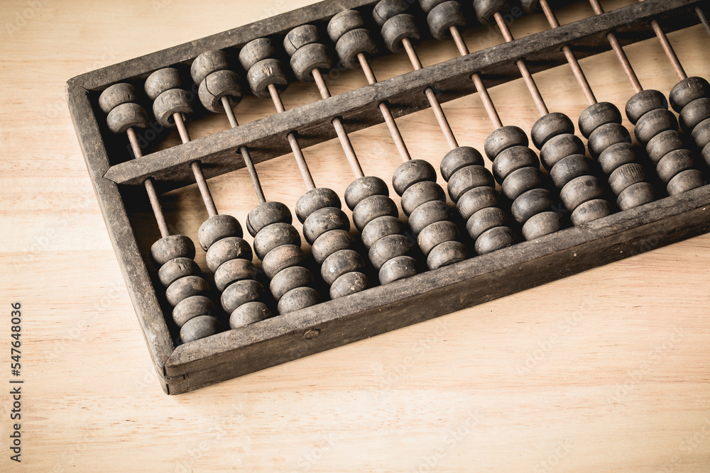 Chinese traditional calculator, old abacus on wooden backgroun Chinese traditional calculator, old abacus on wooden backgroun