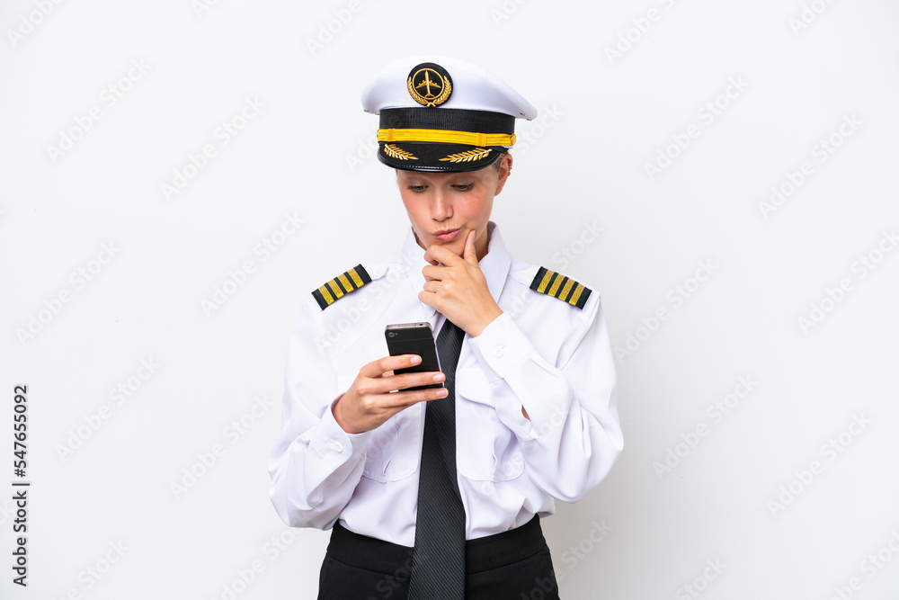 Airplane caucasian pilot woman isolated on white background thinking and sending a message Airplane caucasian pilot woman isolated on white background thinking and sending a message